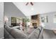 Spacious living room with stone fireplace, hardwood floors, and large sectional sofa at 235 Pine Cone Trl, Ormond Beach, FL 32174