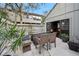 Relaxing patio features a glass-top table and wicker chairs at 235 Pine Cone Trl, Ormond Beach, FL 32174