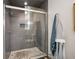 Updated shower with gray tile, pebble floor, and glass enclosure at 235 Pine Cone Trl, Ormond Beach, FL 32174