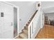 Staircase with white railing leading to the upper level at 235 Pine Cone Trl, Ormond Beach, FL 32174
