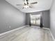Spacious bedroom with grey walls, wood-look floors, and large window at 2888 Berkshire Woods Ter, Deltona, FL 32725