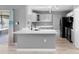 Modern kitchen with island, stainless steel appliances, and white cabinets at 2888 Berkshire Woods Ter, Deltona, FL 32725