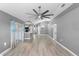 Bright living room with grey walls, wood-look floors, and ceiling fan at 2888 Berkshire Woods Ter, Deltona, FL 32725