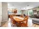 Open concept dining room with wood table and chairs, kitchen and living room views at 304 Gardenia Ave, Debary, FL 32713
