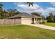 Tan house with a two-car garage and wooden fence at 304 Gardenia Ave, Debary, FL 32713