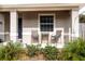 Small front porch with two chairs and a side table at 304 Gardenia Ave, Debary, FL 32713