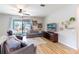 Relaxing living room with gray sofas, large TV, and sliding doors to patio at 304 Gardenia Ave, Debary, FL 32713