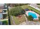 Aerial view of the neighborhood pool and playground with mature landscaping and community walking trails at 3125 Wood Rose Way, Deltona, FL 32725