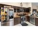 Eat-in kitchen with dark wood cabinets and stainless steel appliances at 3125 Wood Rose Way, Deltona, FL 32725