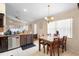 Eat-in kitchen with dark wood cabinets and stainless steel appliances at 3125 Wood Rose Way, Deltona, FL 32725