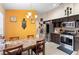 Eat-in kitchen with dark wood cabinets and stainless steel appliances at 3125 Wood Rose Way, Deltona, FL 32725