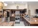 Eat-in kitchen with dark wood cabinets and stainless steel appliances at 3125 Wood Rose Way, Deltona, FL 32725