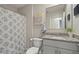 Bathroom with granite vanity and patterned shower curtain at 37 Bella Lago Cir, Port Orange, FL 32129
