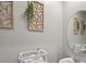 Small bathroom with white sink and vanity, and round mirror at 37 Bella Lago Cir, Port Orange, FL 32129