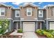Two-story townhome with neutral siding and a two-car garage at 37 Bella Lago Cir, Port Orange, FL 32129