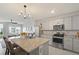 Open-concept kitchen with granite countertops and stainless steel appliances at 37 Bella Lago Cir, Port Orange, FL 32129