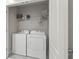 Laundry room with washer, dryer, and shelving at 37 Bella Lago Cir, Port Orange, FL 32129