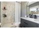 Updated bathroom features a walk-in shower with marble tile and modern vanity at 373 Blythville Ave, Deltona, FL 32725