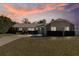 Attractive single-story house with sunset in the background at 373 Blythville Ave, Deltona, FL 32725