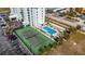 Aerial view of condo building with pool and tennis court at 3800 S Atlantic Ave # 5040, Daytona Beach, FL 32118
