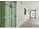 Building hallway with green door to condo unit at 3800 S Atlantic Ave # 5040, Daytona Beach, FL 32118
