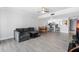 Open concept living area with gray sectional and kitchen access at 3800 S Atlantic Ave # 5040, Daytona Beach, FL 32118