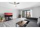 Living room with large TV, balcony view, and wood-look floors at 3800 S Atlantic Ave # 5040, Daytona Beach, FL 32118