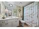 Updated bathroom with a shower/tub combo and floral shower curtain at 395 S Atlantic Ave # 301, Ormond Beach, FL 32176