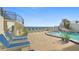 Ocean view pool and deck area with lounge chairs at 395 S Atlantic Ave # 301, Ormond Beach, FL 32176