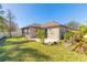 House's backyard with patio, fenced yard, and small pond at 462 Tuscany Chase Dr, Daytona Beach, FL 32117