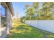 Side yard with grassy area and privacy fence at 462 Tuscany Chase Dr, Daytona Beach, FL 32117