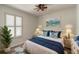 Bright bedroom with a king-size bed, blue accents, and plantation shutters at 462 Tuscany Chase Dr, Daytona Beach, FL 32117