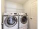 Laundry room with Samsung washer and dryer and overhead shelving at 462 Tuscany Chase Dr, Daytona Beach, FL 32117