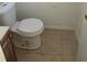 Simple toilet and tile floor in a small bathroom at 5108 Cassatt Ave, Orlando, FL 32808