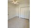 Simple bedroom with tile floors and double door closet at 5108 Cassatt Ave, Orlando, FL 32808