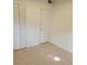 Bedroom with tile floors and louvered closet doors at 5108 Cassatt Ave, Orlando, FL 32808