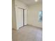 Simple bedroom with tile floors and double door closet at 5108 Cassatt Ave, Orlando, FL 32808