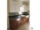 Clean kitchen with dark brown cabinets and tile backsplash at 5108 Cassatt Ave, Orlando, FL 32808