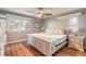 Spacious bedroom with large bed, wood floors, and ceiling fan at 559 Eagle Dr, Daytona Beach, FL 32117