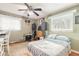 Comfortable bedroom with a window, ceiling fan, and wooden floors at 559 Eagle Dr, Daytona Beach, FL 32117