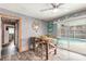 Bright dining area with a wooden table and chairs, sliding door access to pool area at 559 Eagle Dr, Daytona Beach, FL 32117