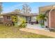 Brick ranch home with a patio, palm trees, and well-maintained lawn at 559 Eagle Dr, Daytona Beach, FL 32117