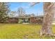Charming brick ranch house with a spacious lawn and large tree at 559 Eagle Dr, Daytona Beach, FL 32117