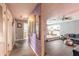 Elegant hallway with decorative wallpaper leading to a modern kitchen and living area at 559 Eagle Dr, Daytona Beach, FL 32117