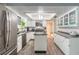 Bright kitchen offers white cabinets, stainless appliances, and a functional center island at 559 Eagle Dr, Daytona Beach, FL 32117