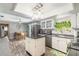 Open-concept kitchen with an island, adjacent to breakfast nook and stainless steel fridge at 559 Eagle Dr, Daytona Beach, FL 32117