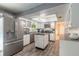 Well-lit kitchen features white cabinetry, stainless steel appliances, and a center island at 559 Eagle Dr, Daytona Beach, FL 32117