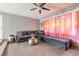 Relaxing living room with a gray sectional sofa and bright, artistic curtains at 559 Eagle Dr, Daytona Beach, FL 32117