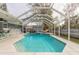 Wonderful pool area with a screened enclosure, ideal for outdoor relaxation and entertaining with a tranquil waterfall feature at 559 Eagle Dr, Daytona Beach, FL 32117