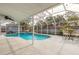 Serene screened-in pool area with comfortable seating and a peaceful ambiance for relaxation and outdoor enjoyment at 559 Eagle Dr, Daytona Beach, FL 32117